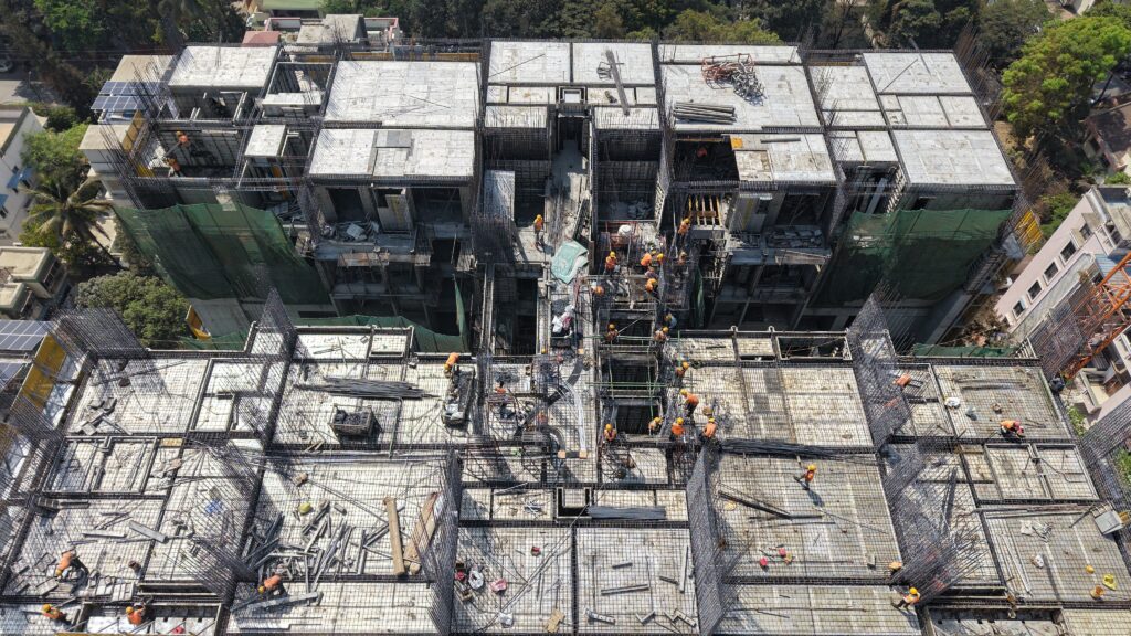 High-rise construction site showing risk of working without safety screen