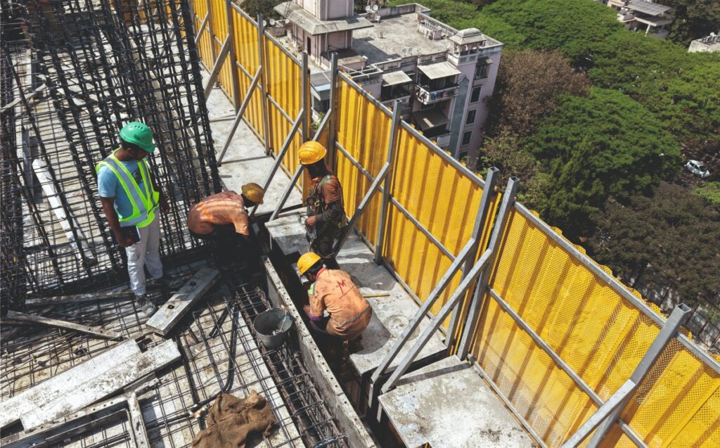 temporary guardrails providing edge protection on high rise construction site